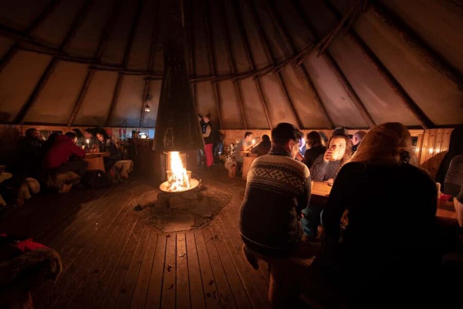 From Tromsø: Northern Lights Visit at Camp Tamok - Sámi lavvu dinner by the open fire: the comfort stop you’ll remember
